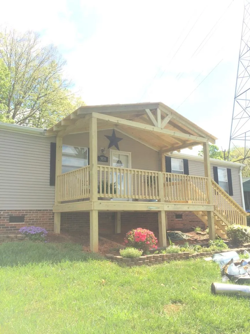 New gabled porch roof and deck railing added to a ranch home in Richwood